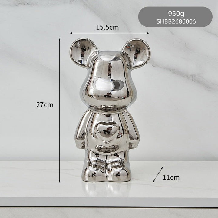 kolorowa rzeźba misia ceramicznego i skarbonka w formie statuetki na biurko
