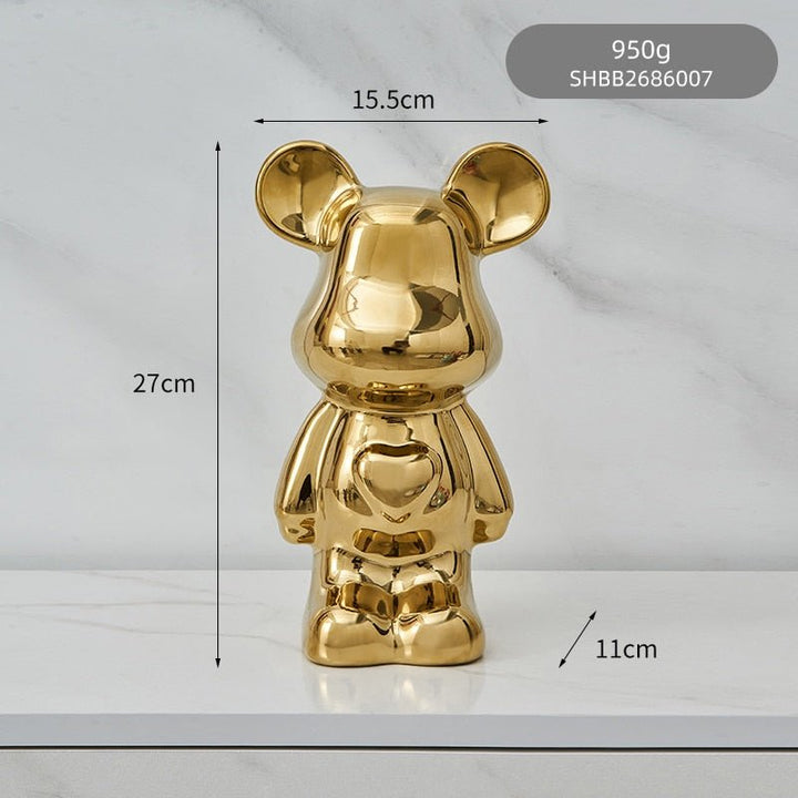 kolorowa rzeźba misia ceramicznego i skarbonka w formie statuetki na biurko