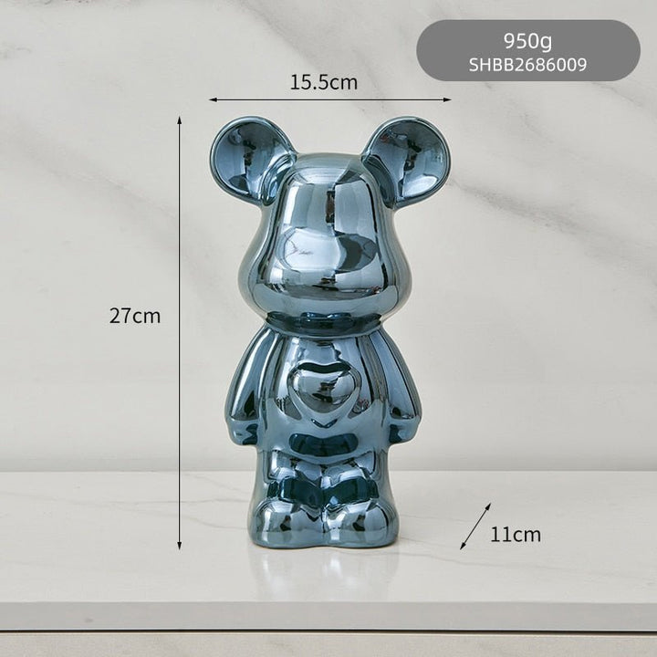 kolorowa rzeźba misia ceramicznego i skarbonka w formie statuetki na biurko
