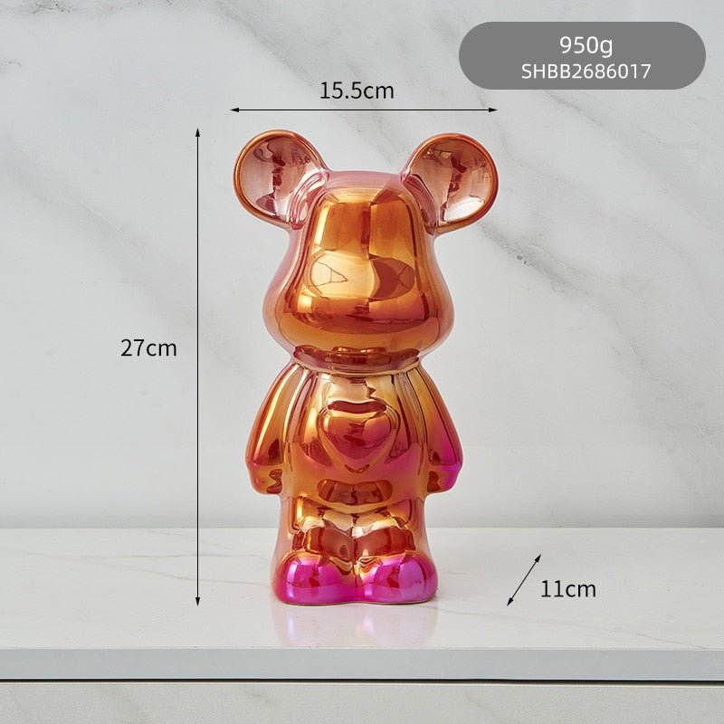kolorowa rzeźba misia ceramicznego i skarbonka w formie statuetki na biurko