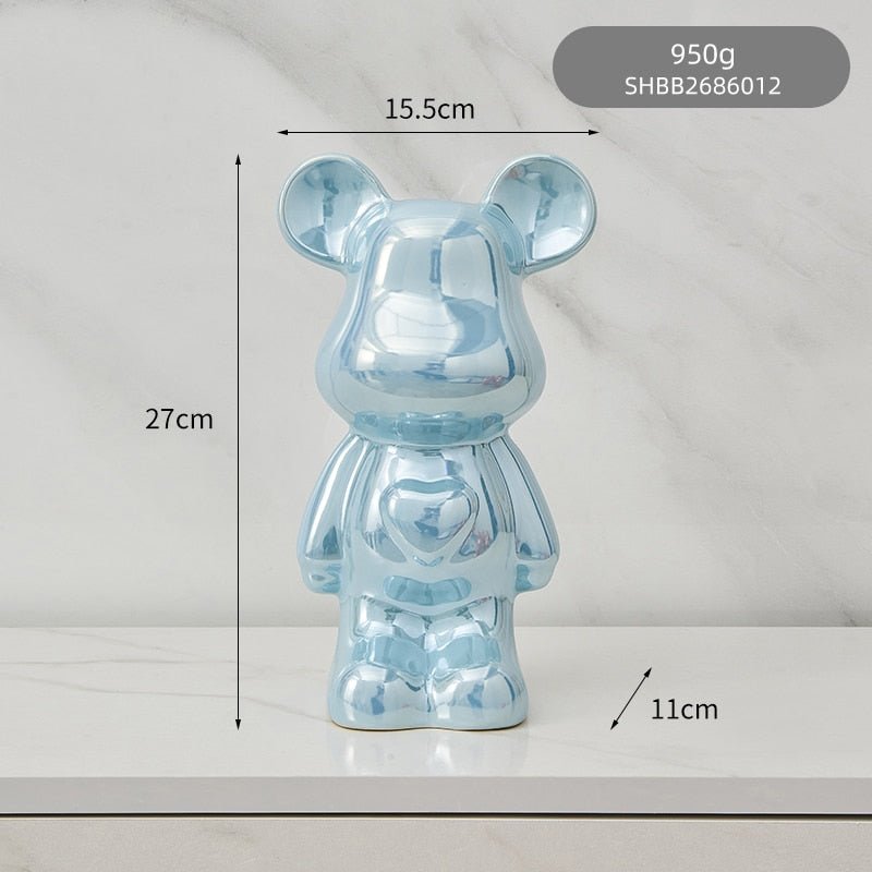 kolorowa rzeźba misia ceramicznego i skarbonka w formie statuetki na biurko