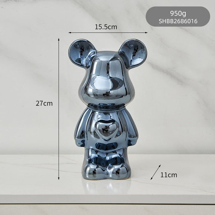 kolorowa rzeźba misia ceramicznego i skarbonka w formie statuetki na biurko